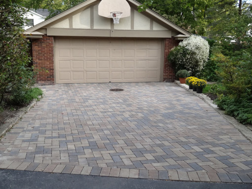 Permeable paving is ideal for a large area, like a driveway. Note the existing catch basin towards the garage door.