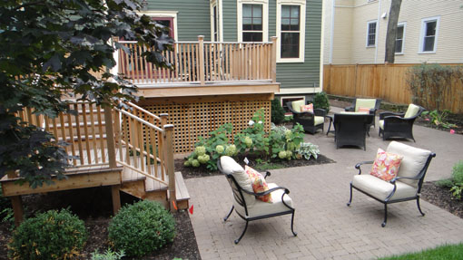 The new, smaller deck is in proportion to the house, and the new patio has two areas for outdoor living.