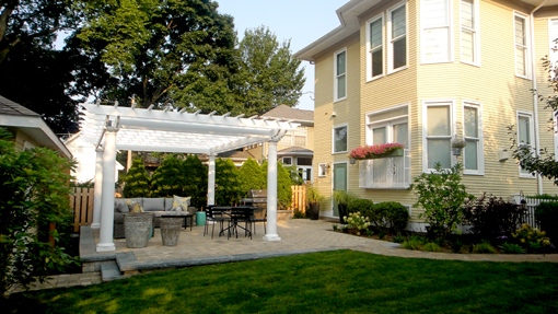 The pergola matches the scale of the house, and is made of maintenance-free fiberglass.