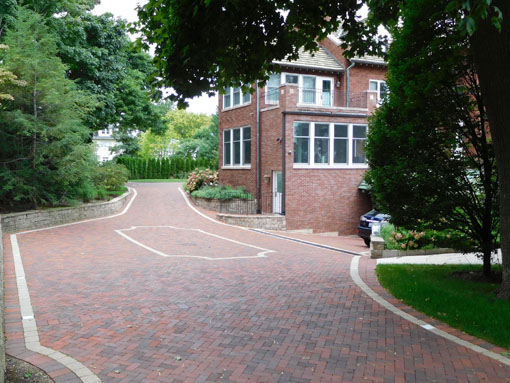 The driveway was re-engineered to prevent cars from scraping the ground when entering the sunken garage (at right).