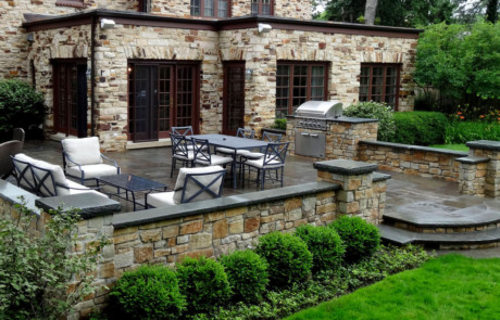 Raised bluestone terrace with mortared stone seat walls and pillars, built in grill and steps