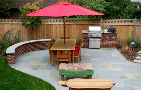 Bluestone patio with mortared brick seatwall and grill