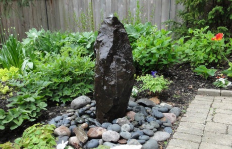 Bubbling rock at edge of patio