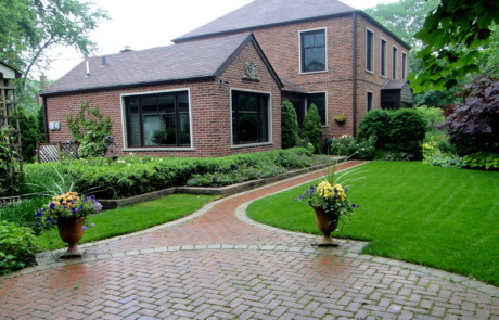private garden with large clay paver patio and walk