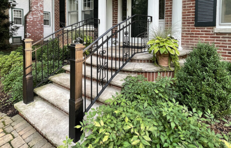 Stone stoop and front steps with iron railing