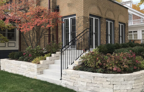 Concrete steps with railing and retaining walls with plantings