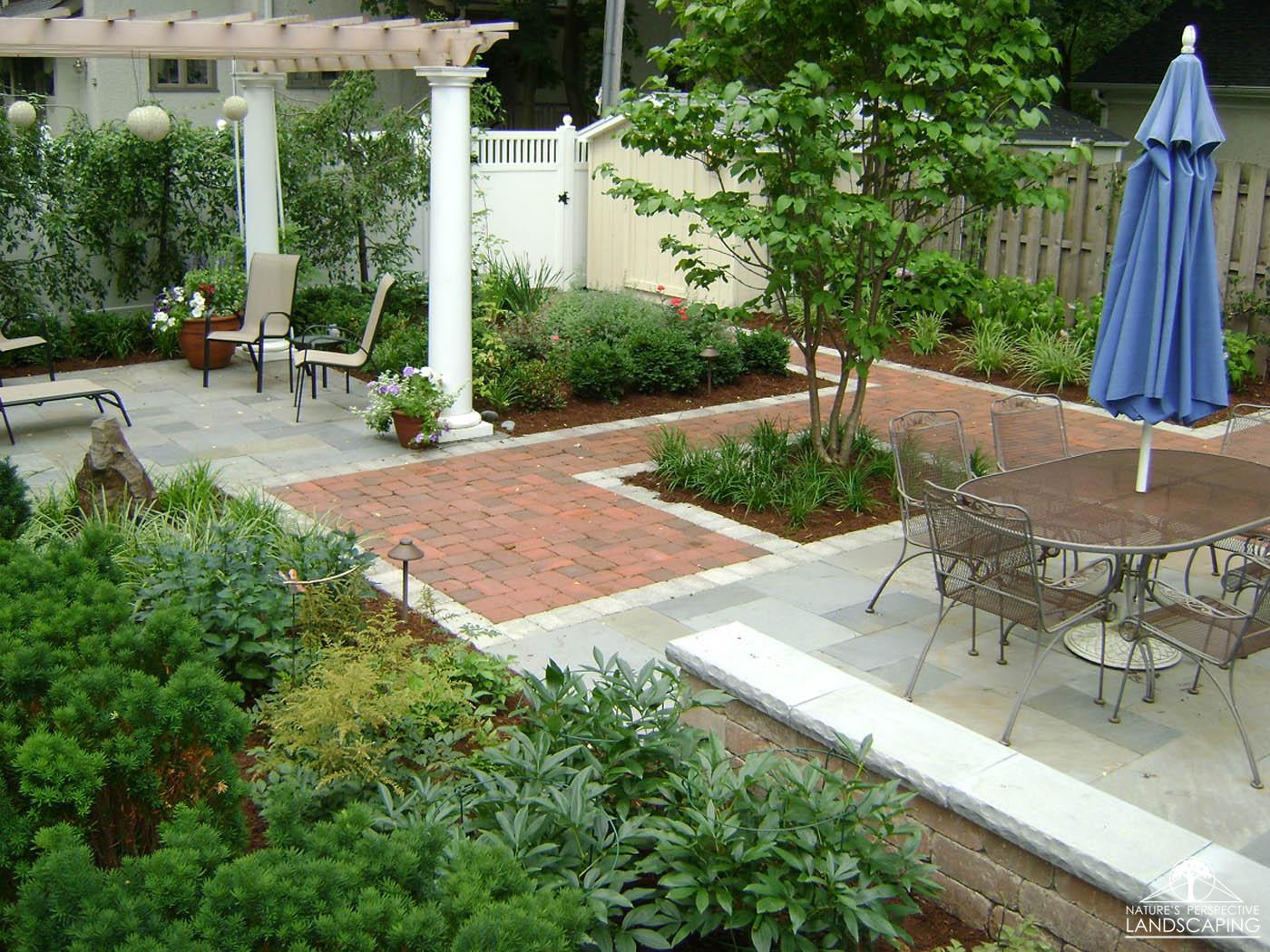 outdoor living rooms with lush plantings and pergola - Nature's Perspective Landscaping