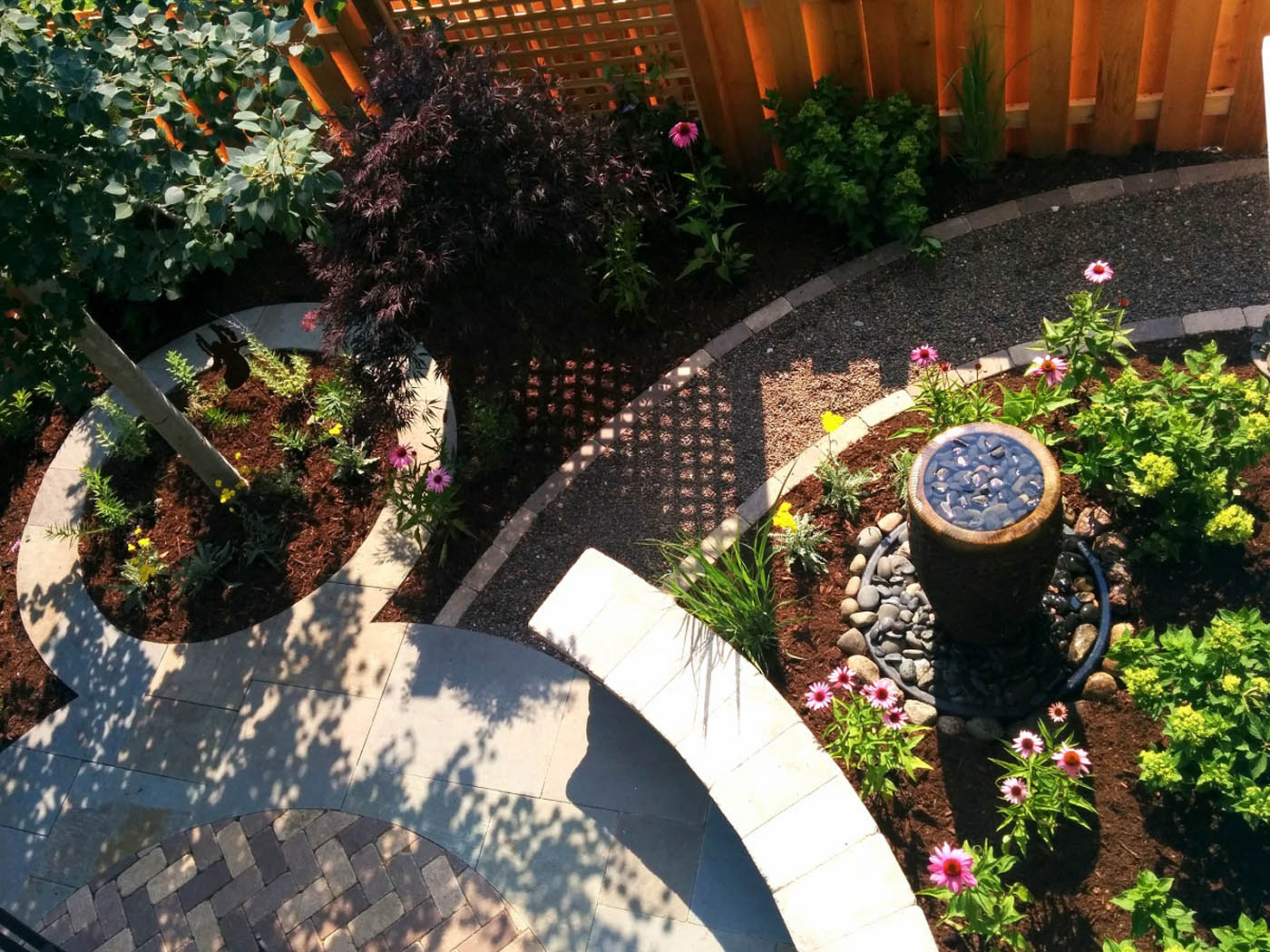 circles, curves small city garden - Nature's Perspective Landscaping