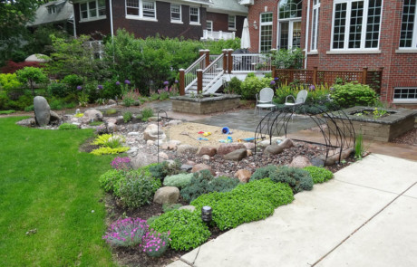 boulder water feature, sand play area, play tunnel and perennials-Nature's Perspective Landscaping