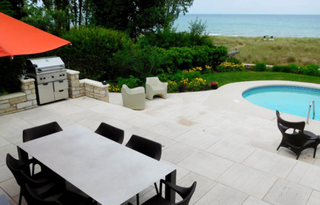 Lakeside travertine terrace with steps and pool
