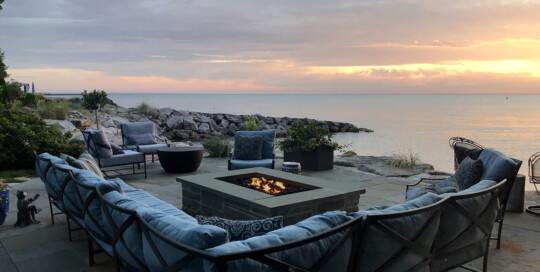 Lakeside bluestone patio with firepit at sunrise