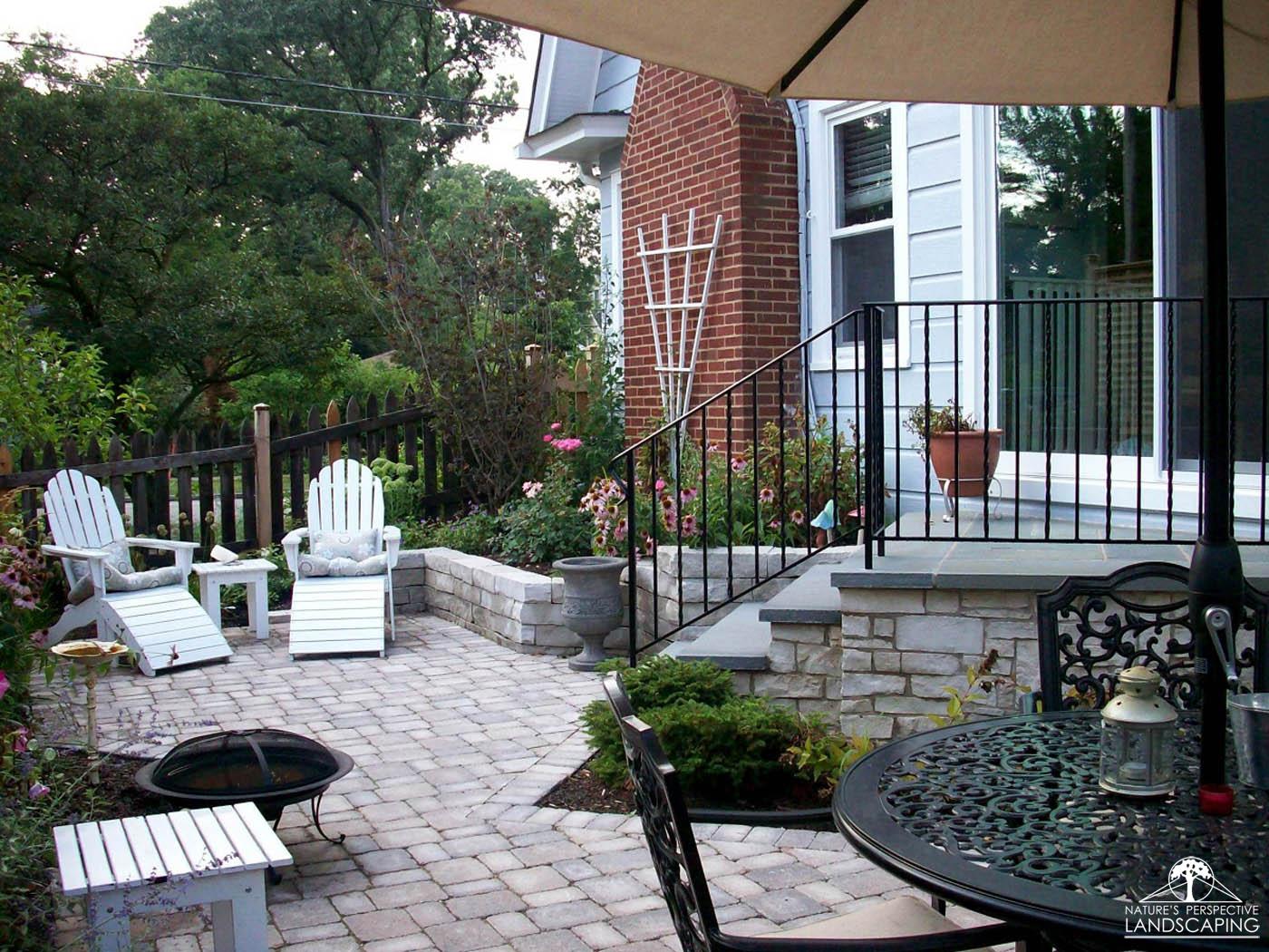 small backyard with angles limestone steps and walls, Brussels Block patioNature's Perspective Landscaping