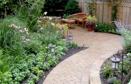 Paved walk and patio with natural plantings