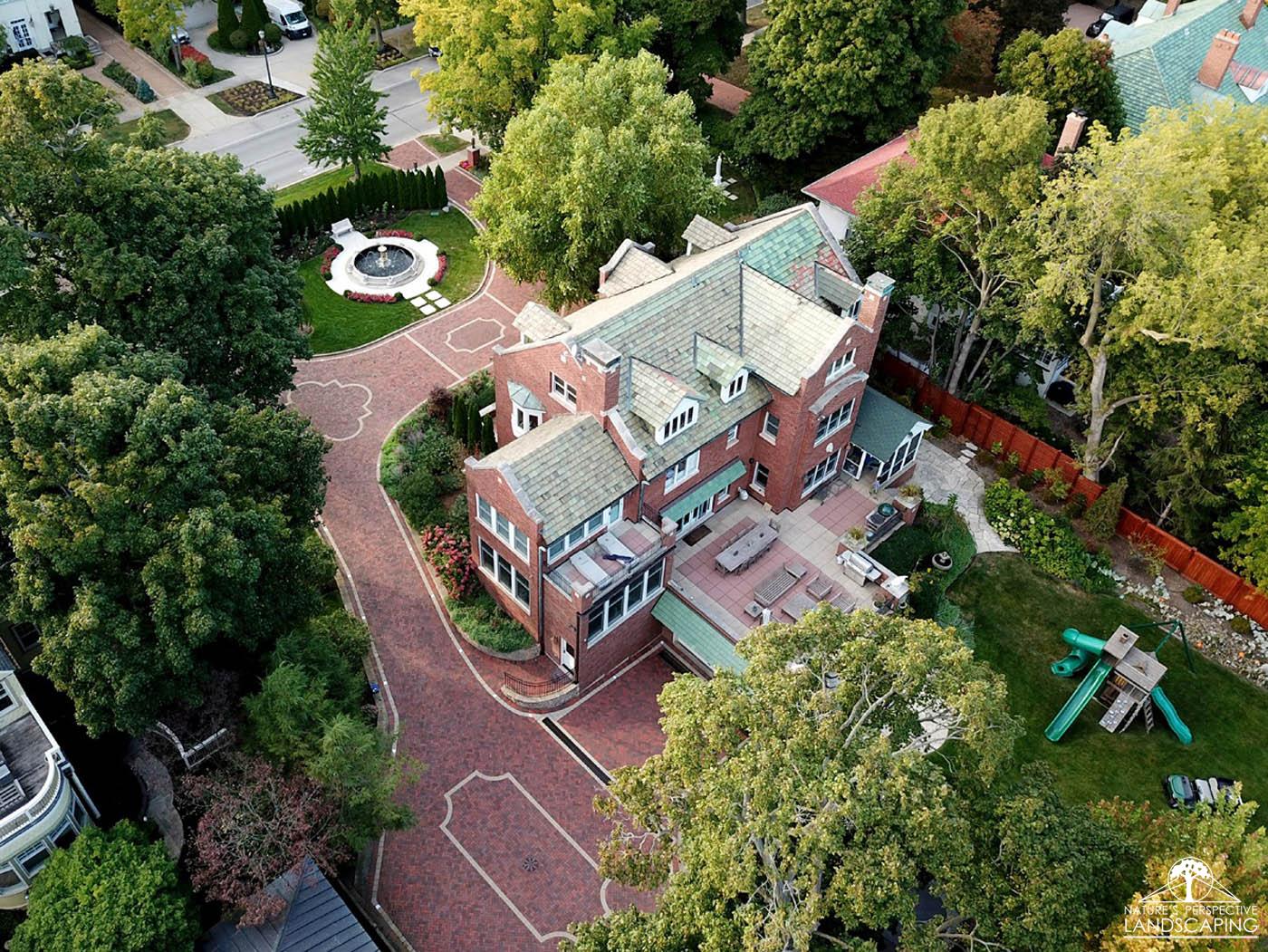 lakefront-estate-drone-drivewayfountain-spray-clay-paver-driveway-Nature's Perspective Landscaping