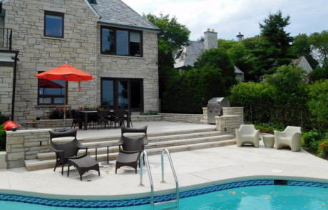 Poolside travertine patio, stone walls and grill niche and Indiana limestone treads