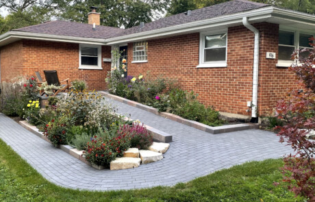 Residential paver ramp entrance with plantings