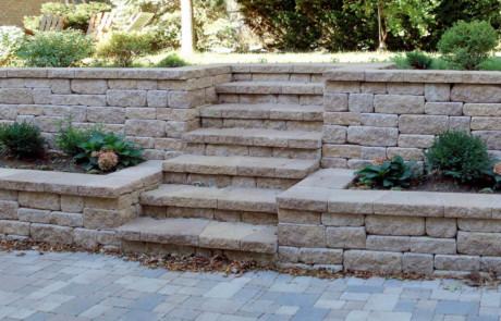 sunken Brussels Block patio with modular retaining wall and steps