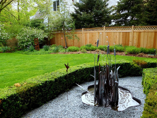 cattails metal garden sculpture in backyard