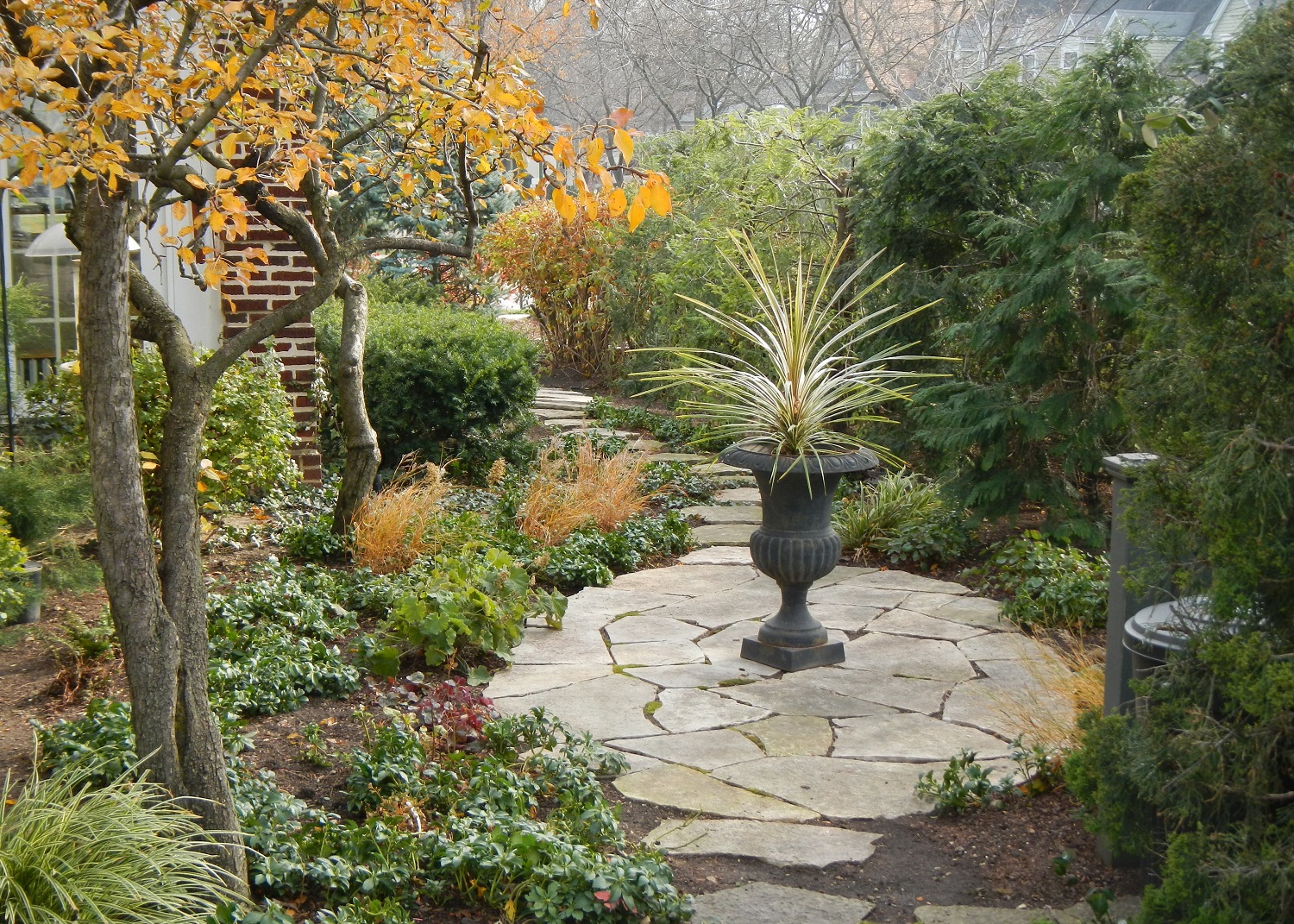 limestone stepstone path with round patio and urn