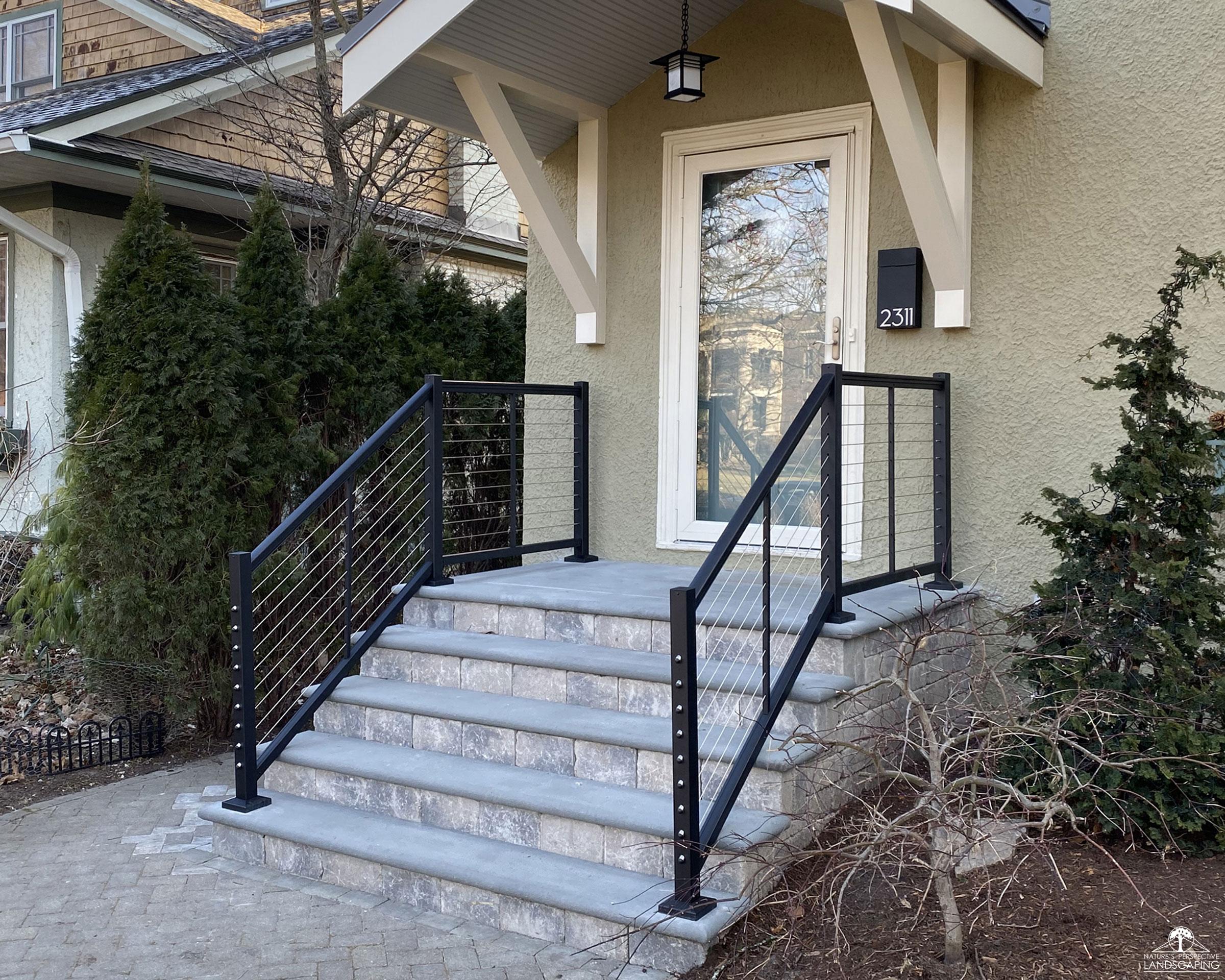 new modular front stoop with contemporary metal railings
