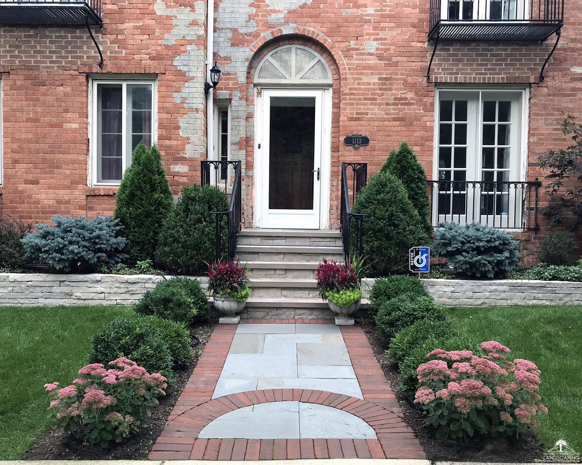 mortared limestone stoop and steps, dry-laid limestone wall and bluestone and brick front walk