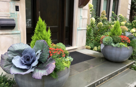 Two large fall containers on front steps