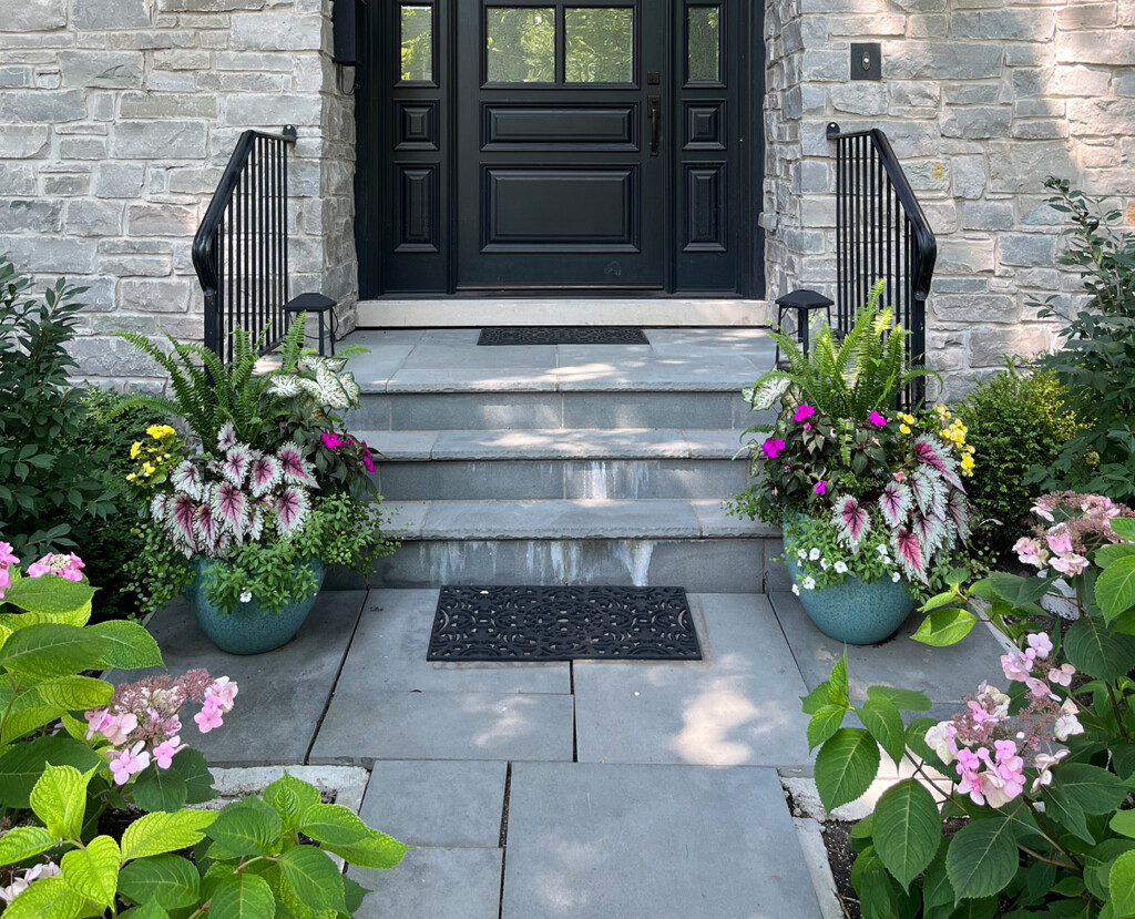 Two summer containers at base of steps.