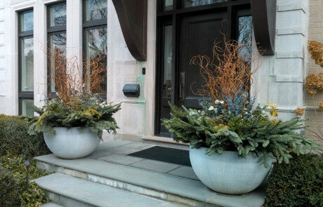 Two large winter containers on steps